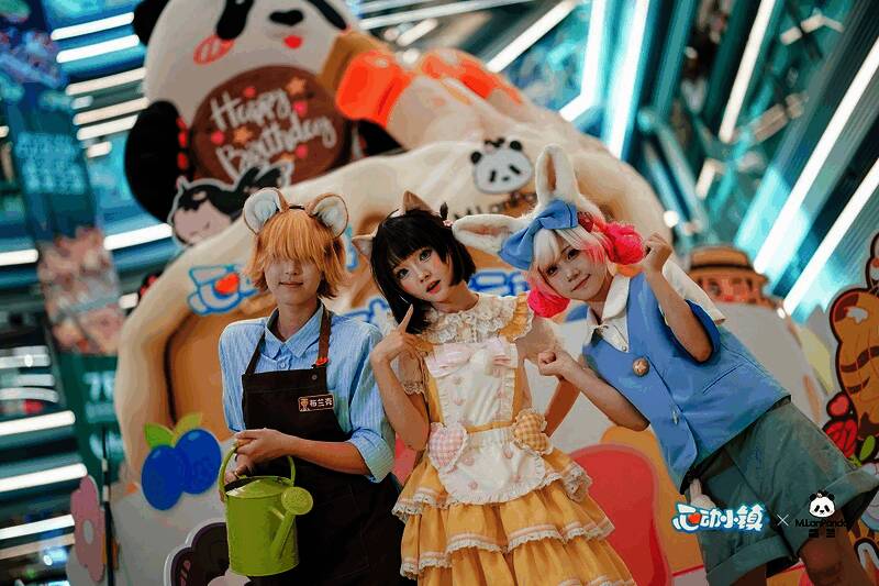 现场布置充满卡通风格，背景板上是游戏中的角色形象