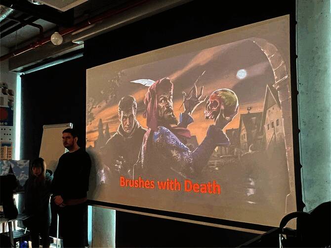 工作室内部场景，多名开发者正在电脑前专注工作，墙上展示着游戏概念图