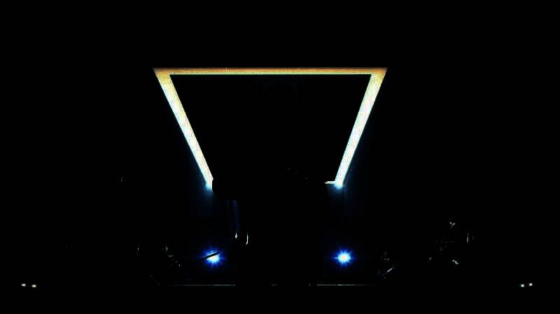 小队成员在建筑内协同推进，一人使用热成像探测墙体后敌人