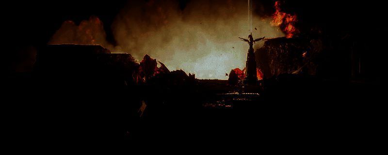 《绝地潜兵2》游戏中玩家手持解放者步枪对抗生化人敌人的战斗画面，背景为未来都市废墟，敌人头部火花四溅，展现精准爆头瞬间