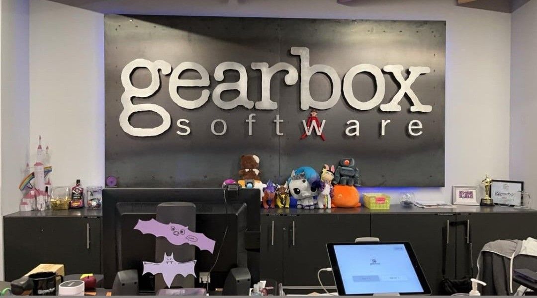 《无主之地4》实机画面截图，角色在荒原中与机械敌人激烈交火，画面风格延续系列夸张色彩