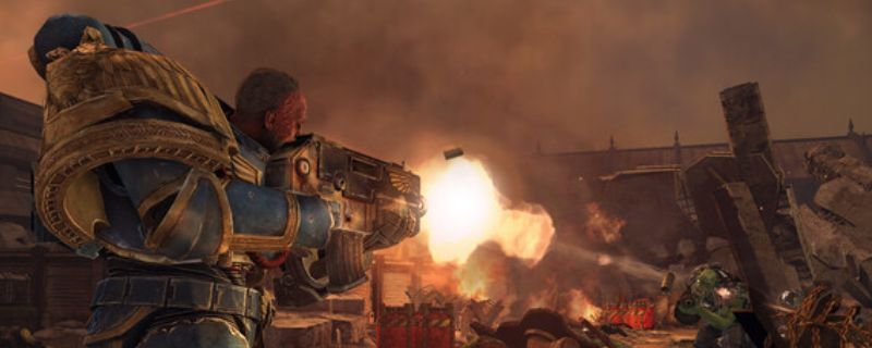 《战锤40K：星际战士复刻版》游戏封面图，展示主角身穿重型动力装甲持枪站立的霸气形象，背景为战火纷飞的战场