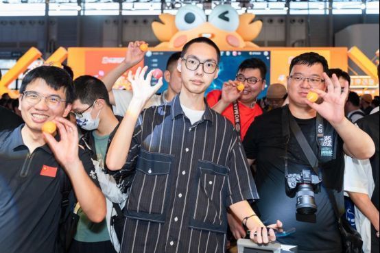 现场观众举着红黄双色乒乓球积极参与互动，气氛热烈