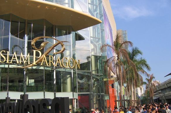 任天堂店内景，玩家正在体验Switch游戏，货架上陈列着各类游戏卡带与周边产品，氛围热烈