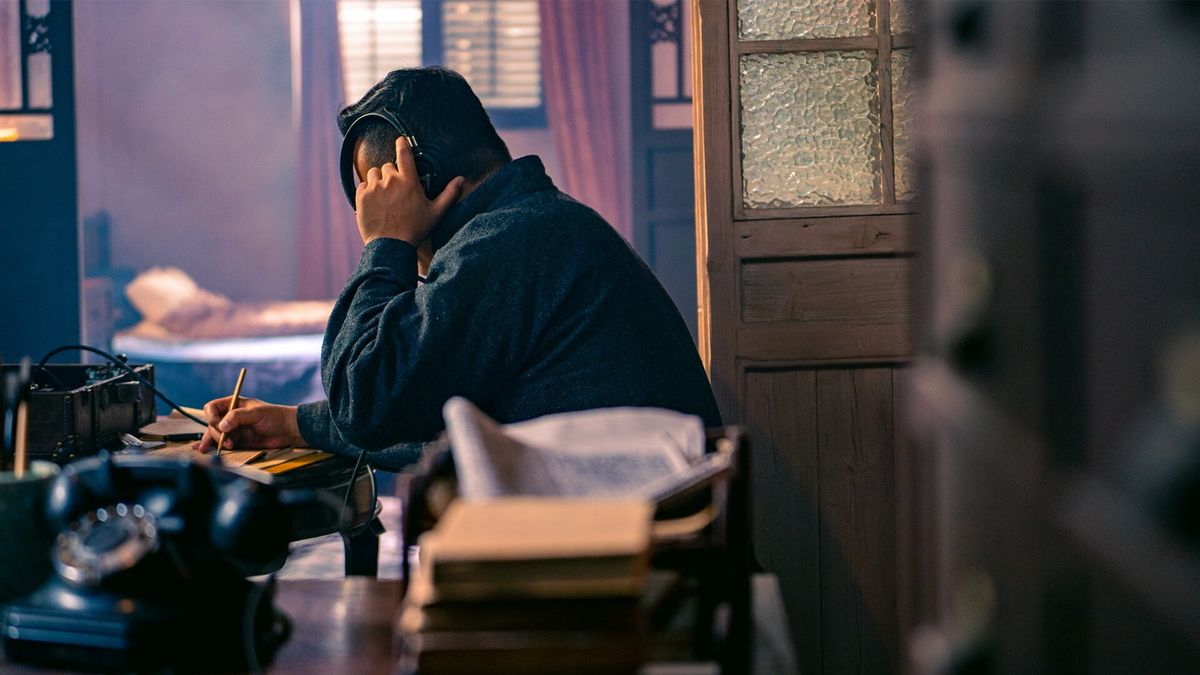 主角在昏暗钱庄内对峙，桌上散落账本与手枪，光影交错，气氛紧张