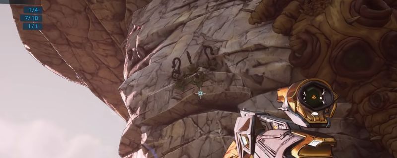 《无主之地4》废弃哨站场景，荒凉废墟中散落着机械残骸与战斗痕迹，远处可见任务NPC站立的身影