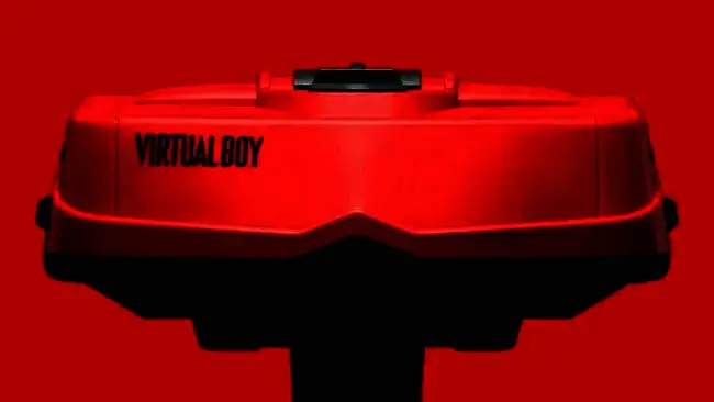 Virtual Boy掌机正面特写，红色显示屏亮起，展现出独特的单色视觉效果，周围为黑色塑料机身