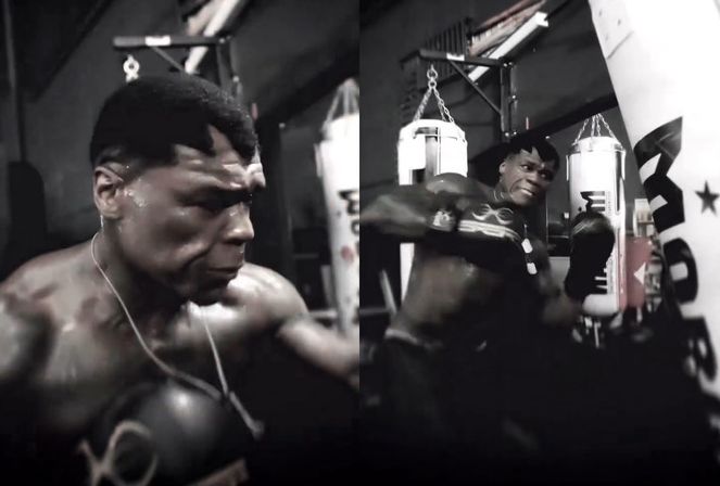 50美分身穿训练背心进行力量训练，面部表情凶狠，背景为健身房环境